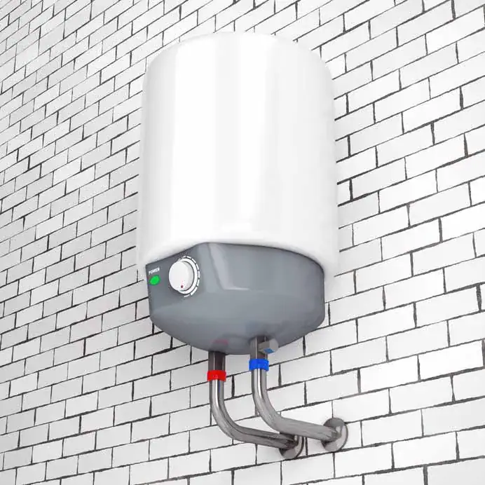 A white electric water heater is mounted on a white brick wall. The heater has a control knob and indicator lights, with metal pipes for hot and cold water connected at the bottom.